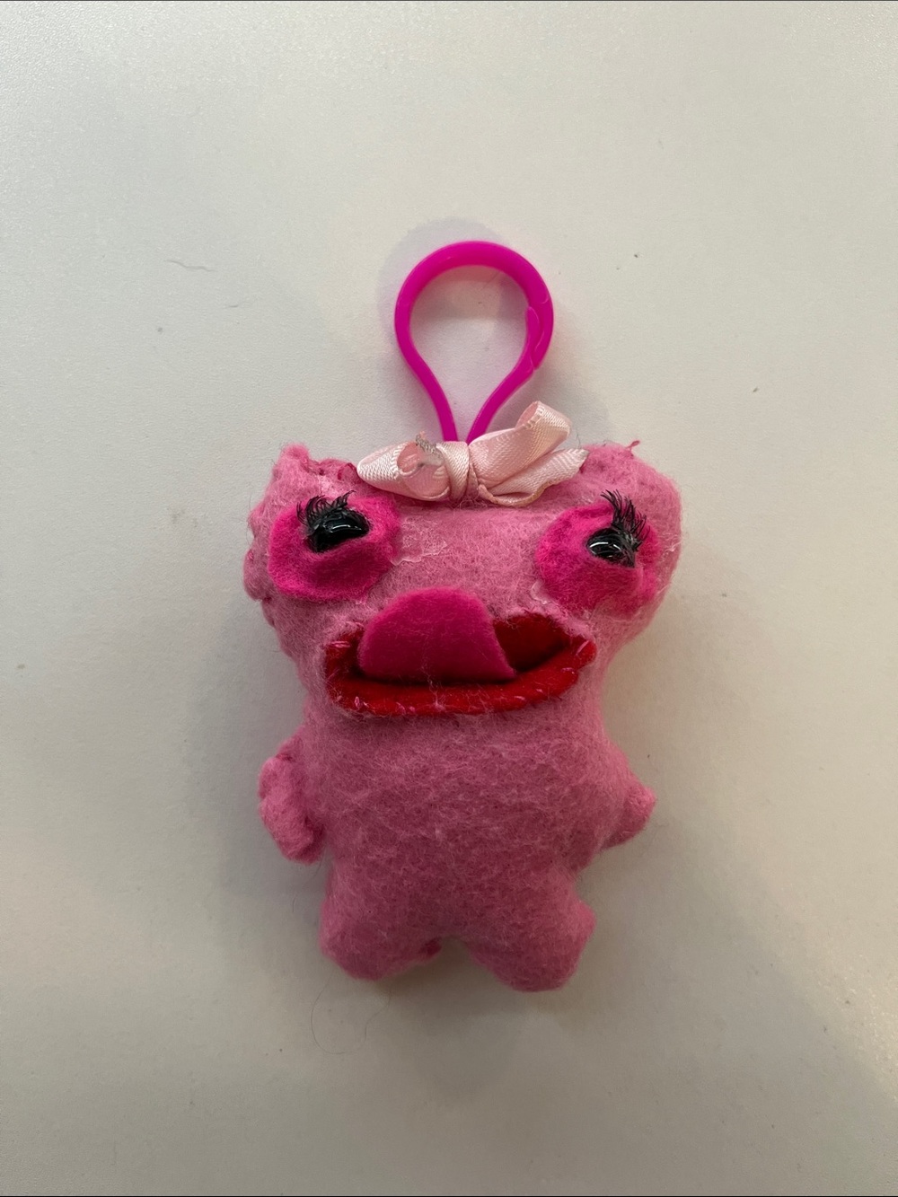 Handmade pink  fugly fuggler keychain with lashes and a pink bow 🎀